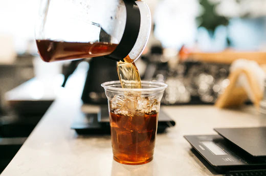close up image of iced pour over being poured into cup